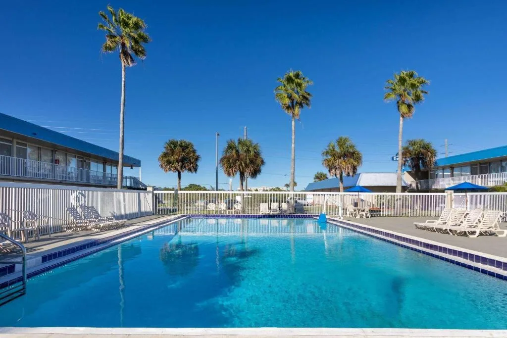 Ligbedden aan het buitenzwembad van het Hotel Days Inn Wyndham Kennedy Space Center